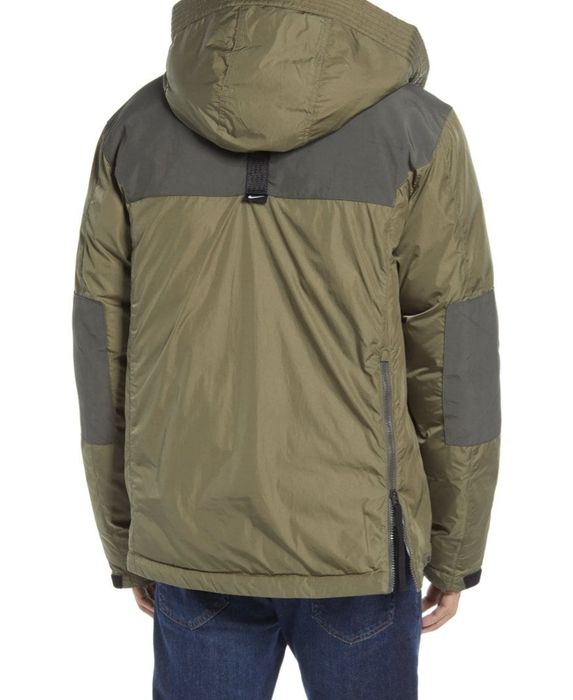 Back view of the same model wearing the lined green anorak