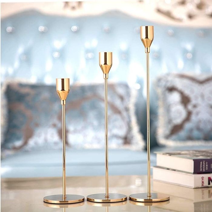 A collection of three candle holders in varying heights, designed to create visual interest.