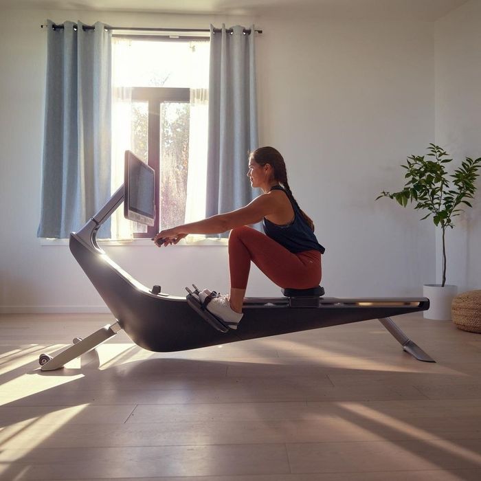 A model demonstrating how to use a rowing machine with perfect technique.