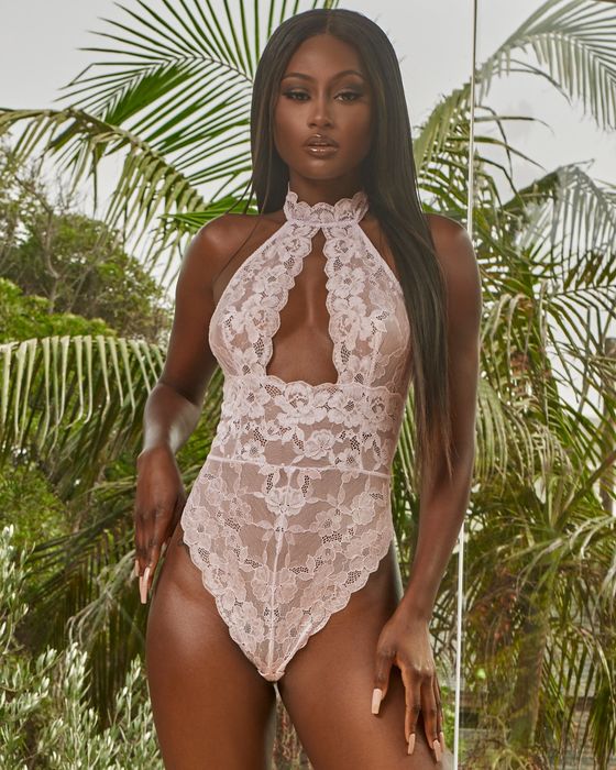 A model showcasing a high-neck, orchid-colored one-piece lingerie set.