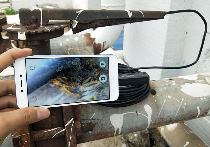 The perspective from the compact camera, streamed on a phone, revealing unseen details in tight areas.
