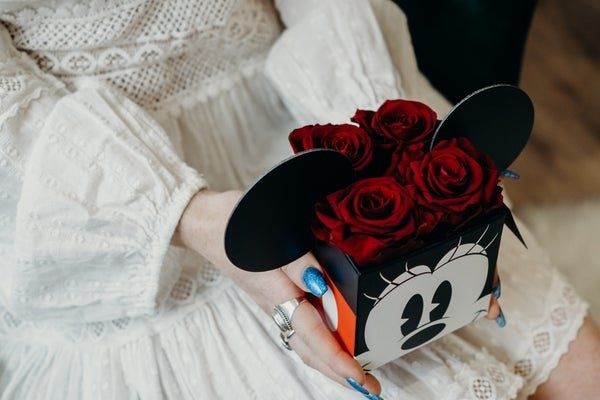 a Minnie Mouse-themed box containing four stunning roses