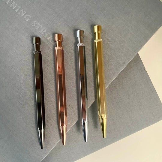 a set of metallic pens with blue and black ink that offer a touch of elegance to every note