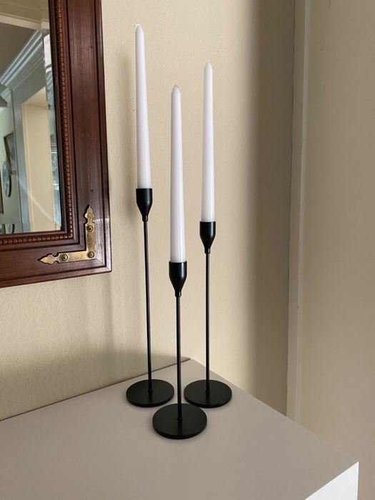 A reviewer's candle holders in black, placed elegantly on a mantle.