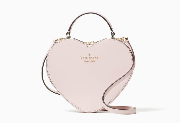 a light pink heart-shaped Kate Spade purse