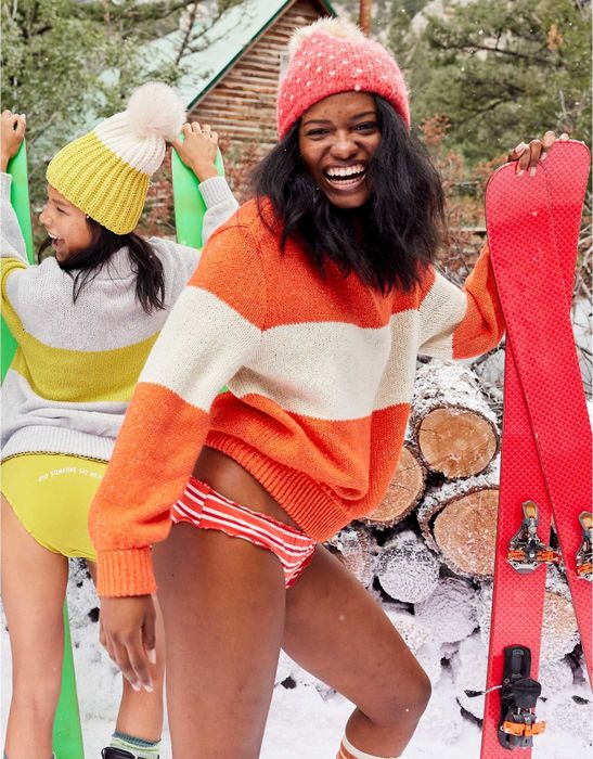 another model rocking the sweater in orange and tan colors