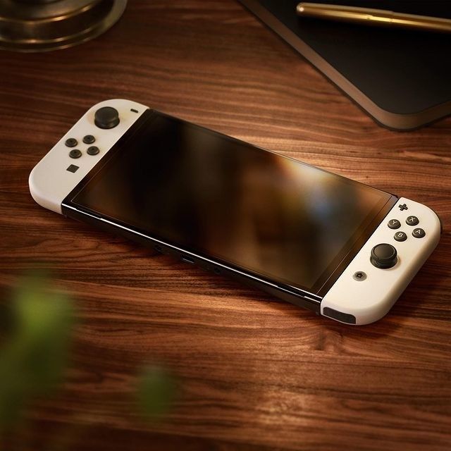 A sleek white Nintendo Switch OLED, showcasing its vibrant display and modern design.
