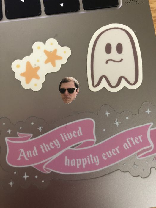 a small sticker featuring the writer's husband's face