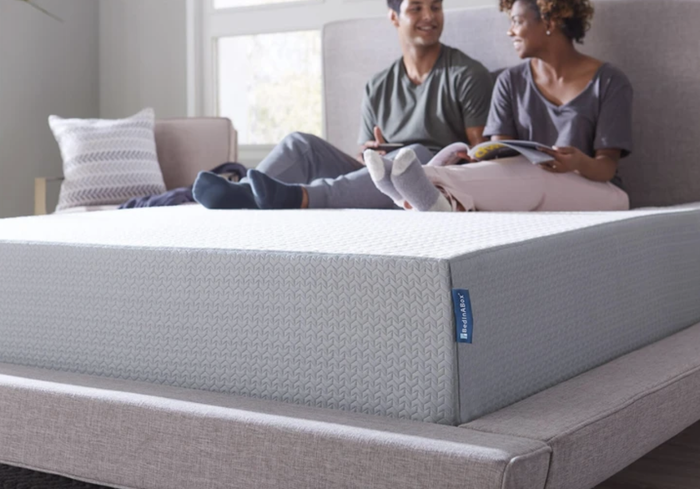 A couple relaxing together on a Bed In A Box mattress.