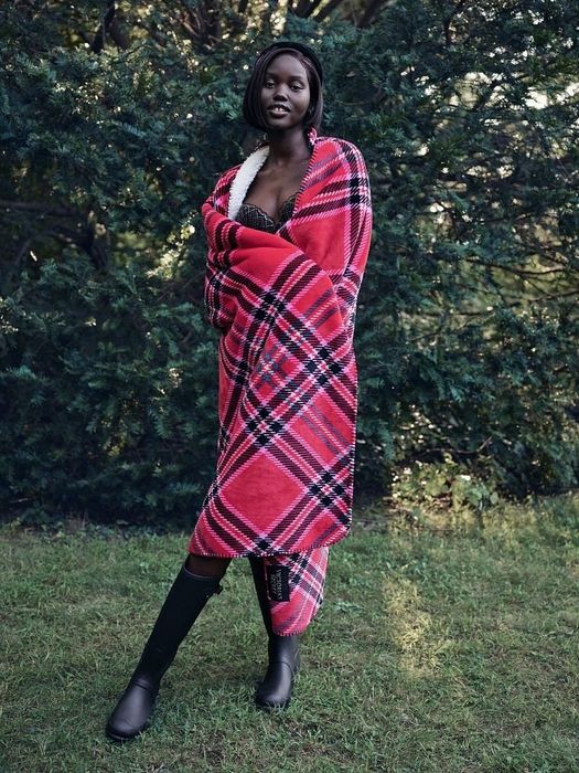 A model wrapped in a cozy sherpa blanket
