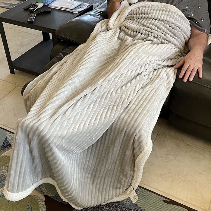 A reviewer shared an image of a person snuggled up with the blanket.