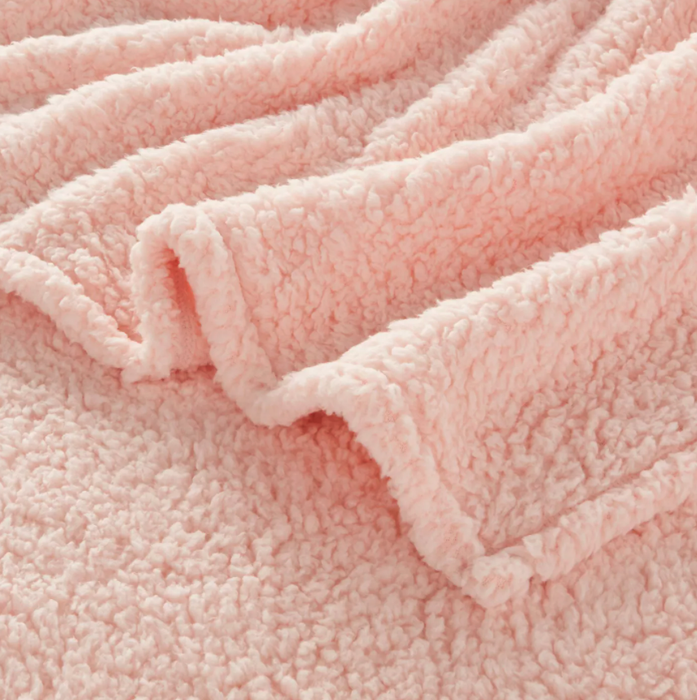 A close-up image showcasing a soft, pink blanket.