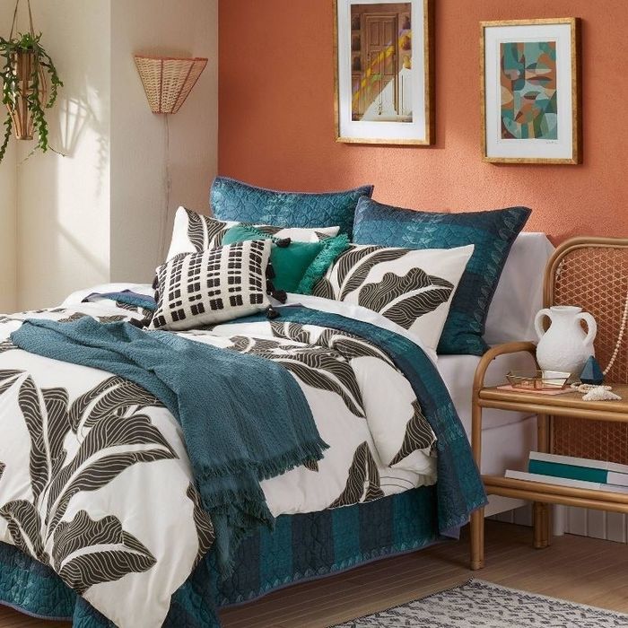 a teal-colored blanket elegantly draped over a bed