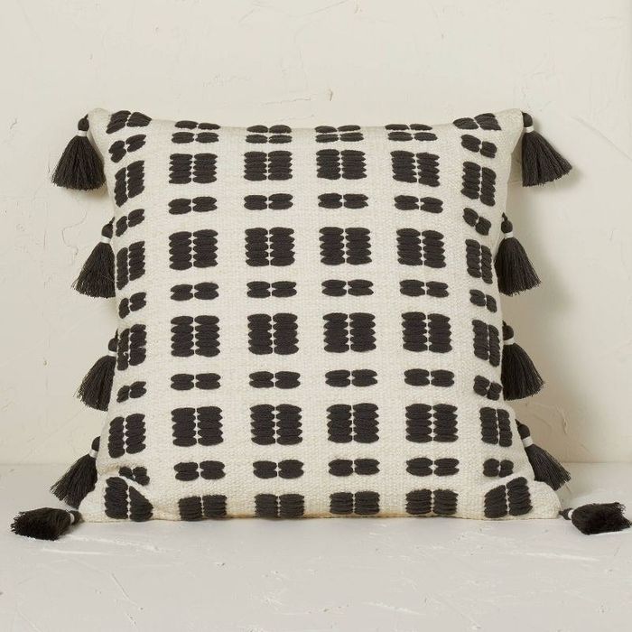 a beautifully crafted pillow featuring a blend of brown and cream woven fabric