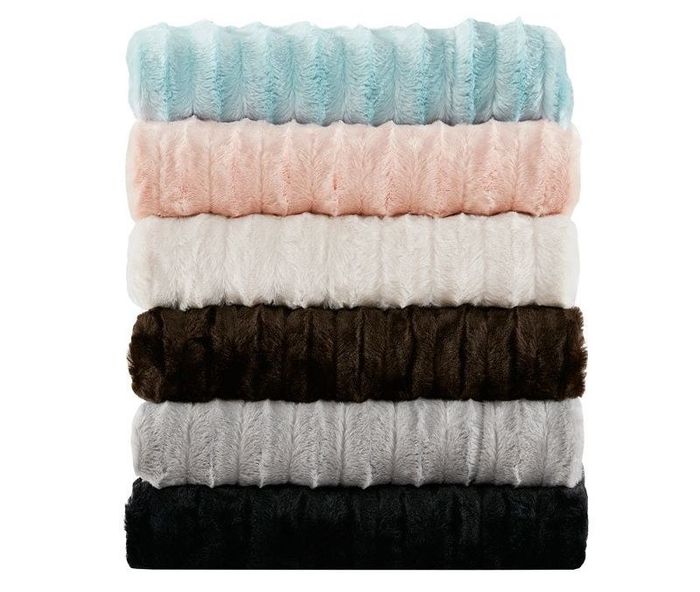 A collection of faux fur blankets in various colors, perfect for adding warmth and style.