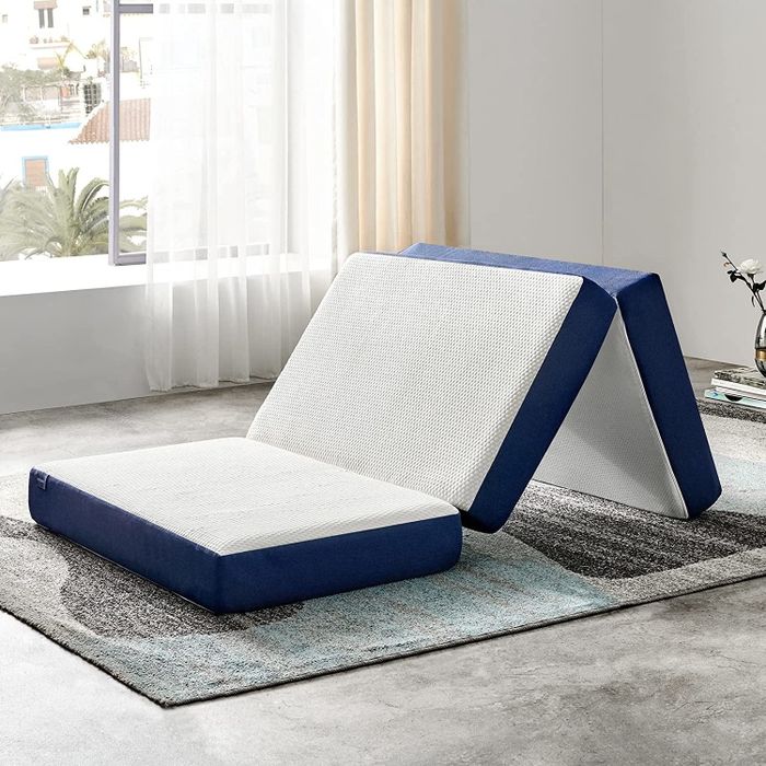 A mattress being unfolded for easy setup and storage