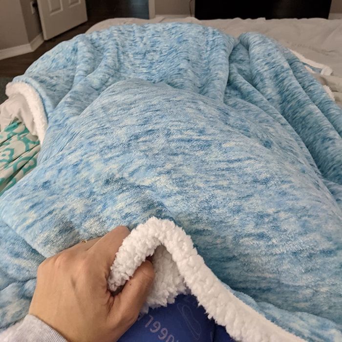 A reviewer shared a photo of a blue and white blanket.