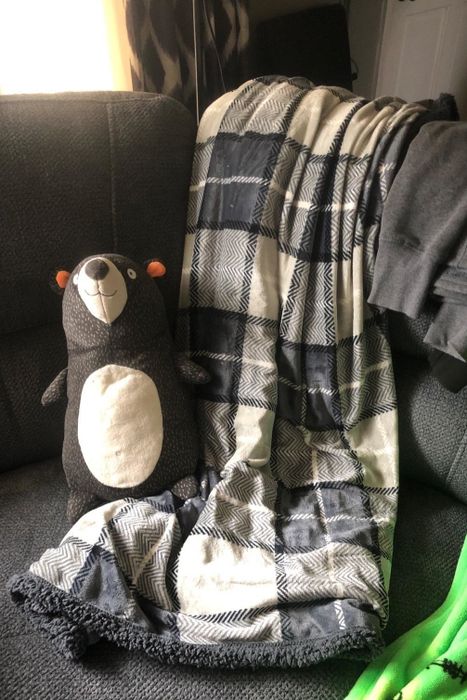 A reviewer posted a picture of a black and white plaid blanket.