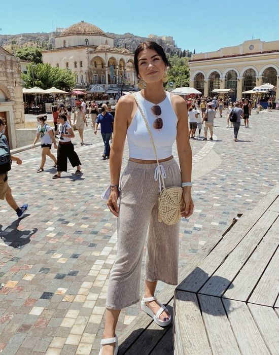 A reviewer wearing the top in white