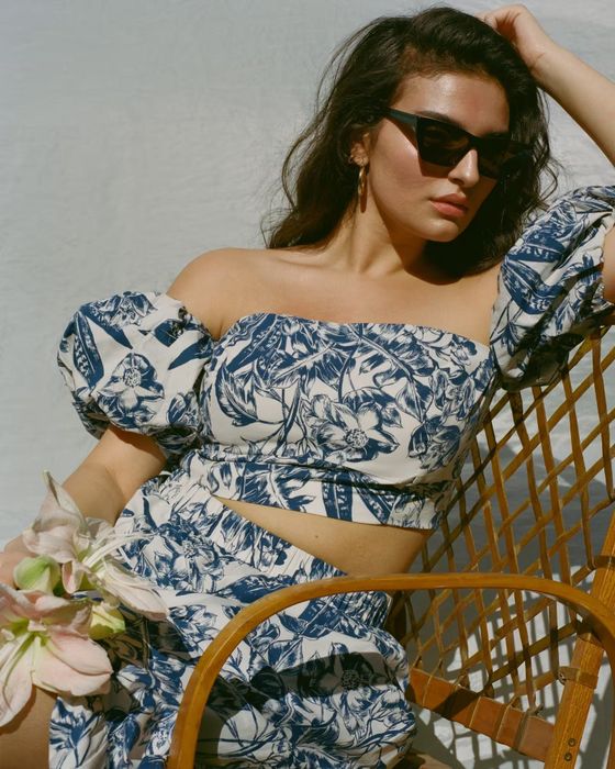 A model showcasing a floral puff-sleeve crop top