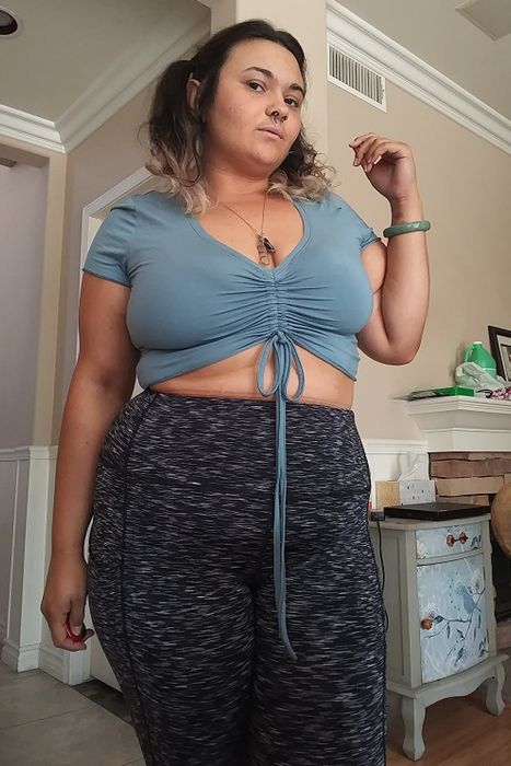 A reviewer flaunting the light blue crop top.