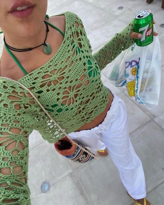 A model wearing the crocheted shirt over a bikini.