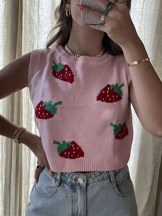 A reviewer rocking the pink strawberry sweater.