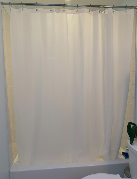 A photo from a reviewer showing the white liner hanging on their shower-tub combo.