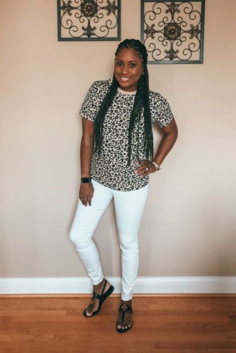 A customer styling the leopard print tee with white jeans.