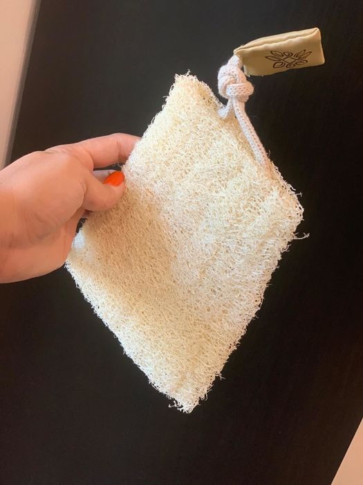 A reviewer's photo of the loofah lying flat, freshly unpacked from its packaging.