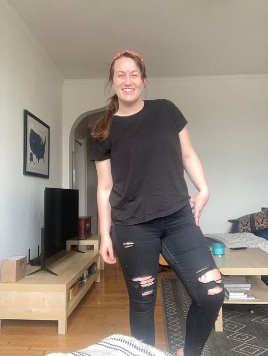 A reviewer rocks a casual look with black distressed jeans and a simple black tee.