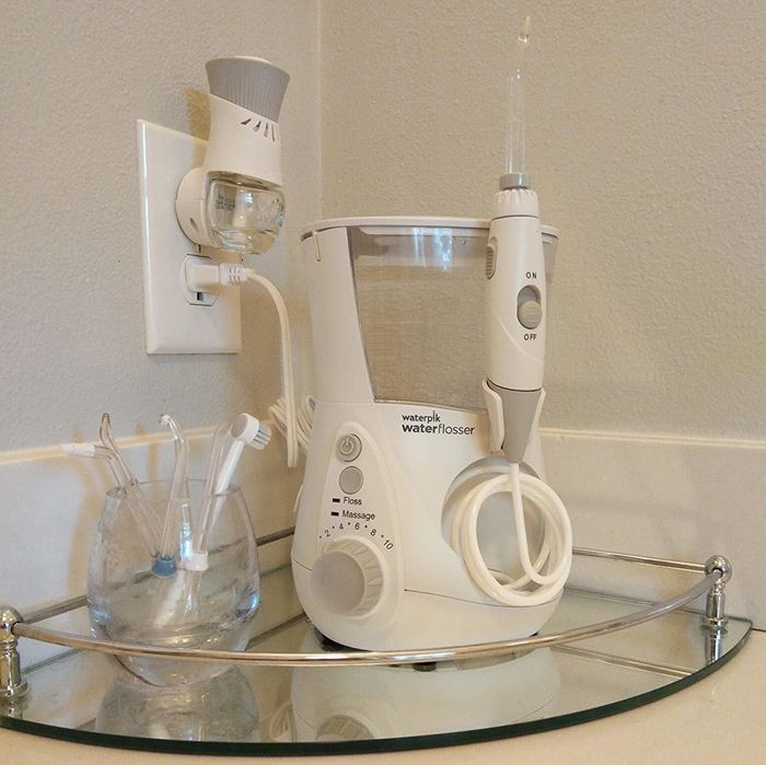 A reviewer's photo of the WaterPik placed on a mirrored tray.