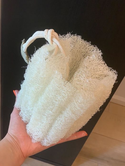 A reviewer's photo of the same loofah fully soaked, as recommended in the pre-soak instructions.