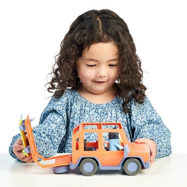 Girl having fun with her Bluey jeep