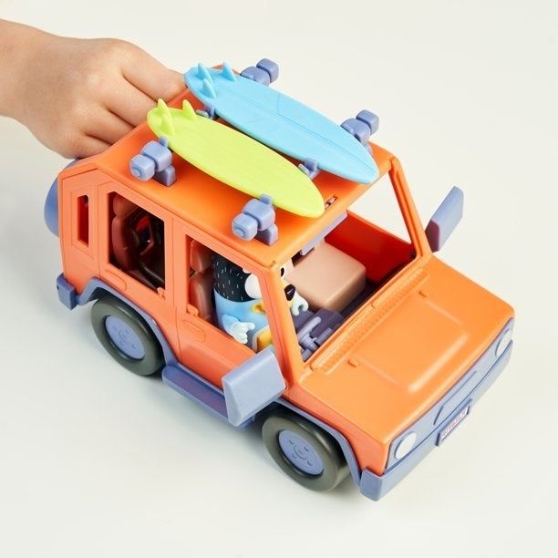 Kid enjoying playtime with the Bluey jeep