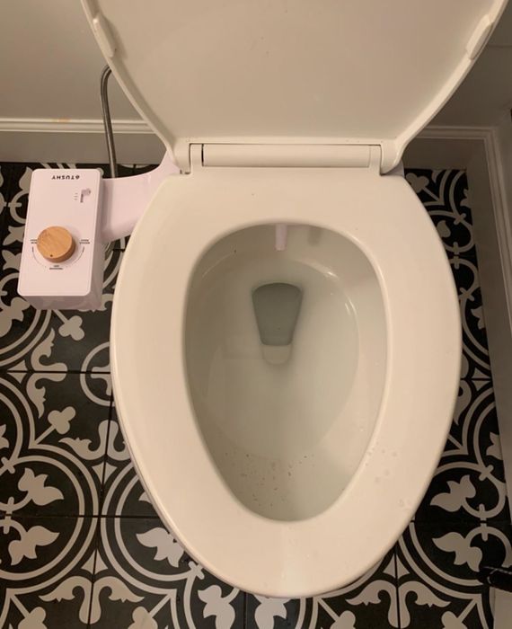 A photo shared by a reviewer showing a toilet with a bidet attachment installed.