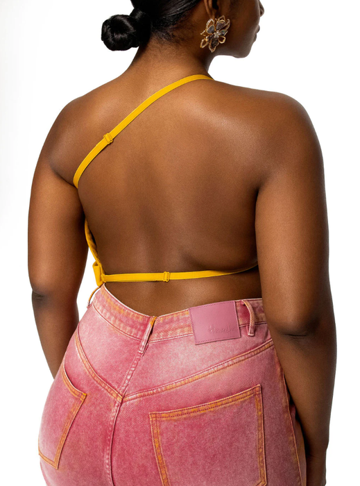 A model showcasing the straps on the back of the top.