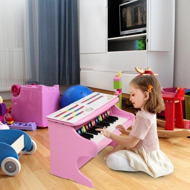 Child enjoying playing on a small piano