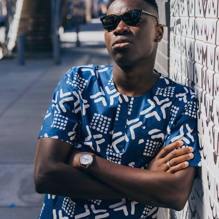 A model wearing a blue and white printed shirt.