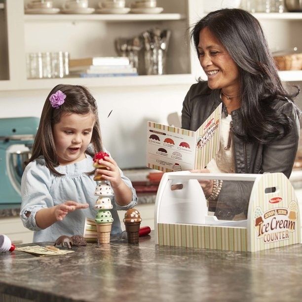 Kid using ice cream set with parent