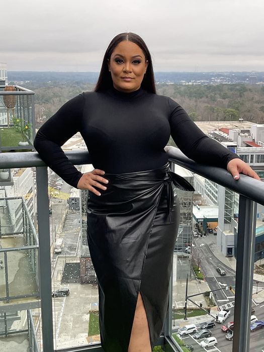 reviewer modeling the black faux leather skirt