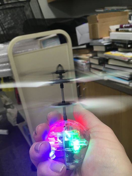 The glowing disco ball held in the reviewer's hand.