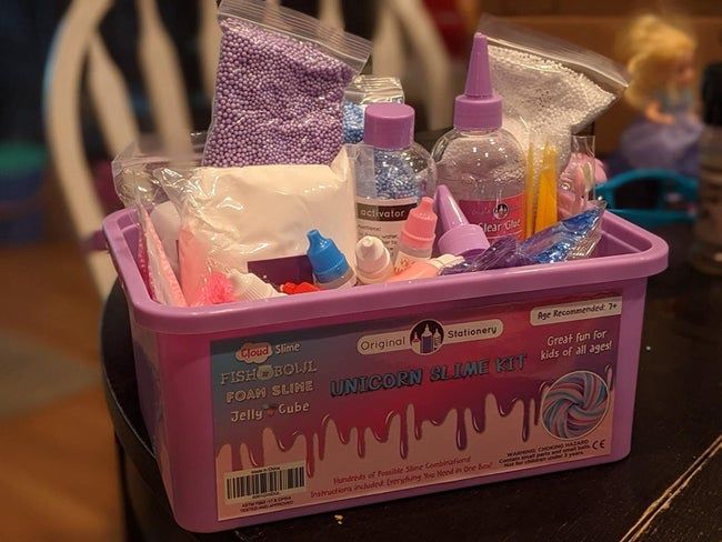 The Unicorn Slime kit opened to showcase its fun and sparkly contents.