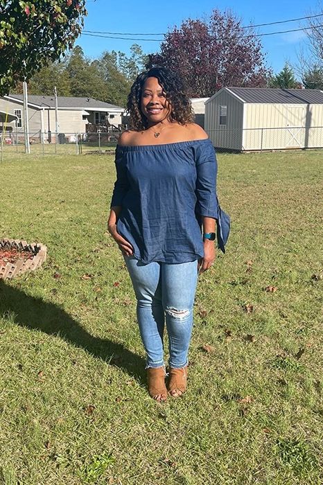 A customer review photo of them wearing the top in blue