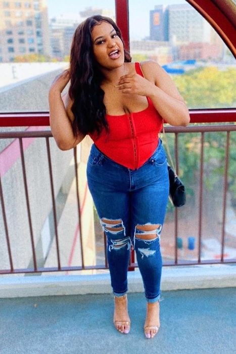 A customer review photo of them wearing the bustier crop top in red