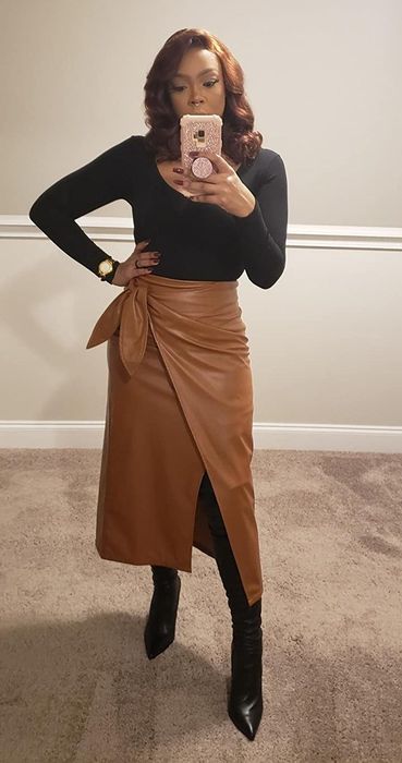 another reviewer wearing the brown faux leather wrap skirt