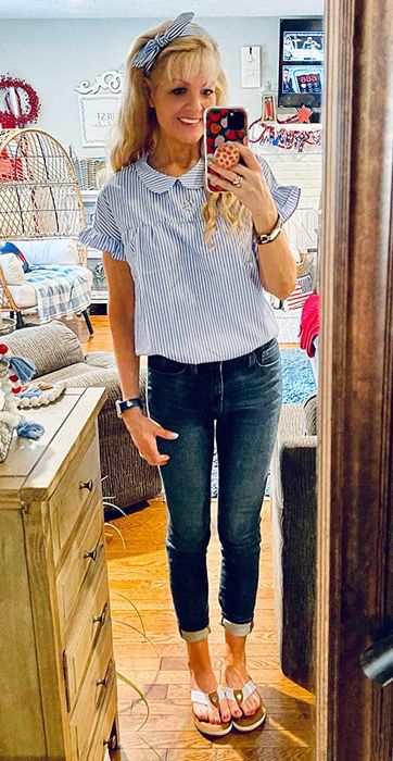 A customer review photo of them wearing the shirt in blue, paired with a matching headband
