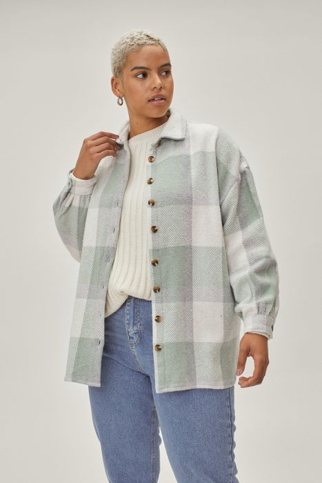 The model is wearing a stylish mint and grey plaid shacket.