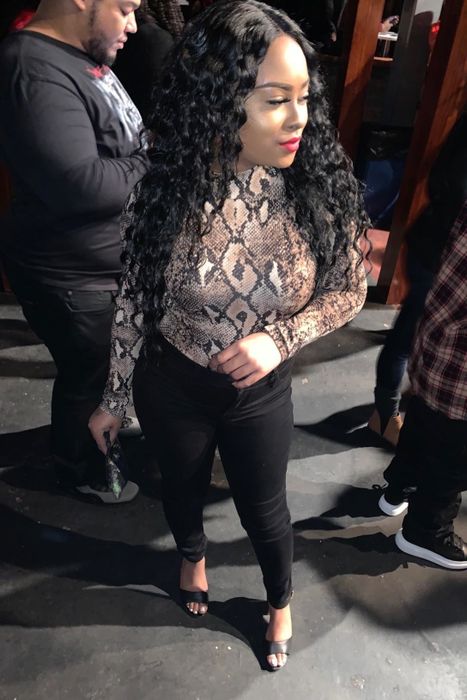 A customer review photo of them wearing the bodysuit in snake print