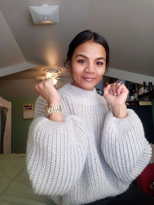A customer review showing off the gray sweater's sleeves in style